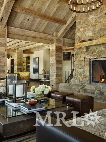 A photo of our reclaimed hand hewn timbers and slabs used to clad posts, coffer ceilings, frame entrances, and side the exterior along with corral board accents featured throughout the Ranch 1 project.