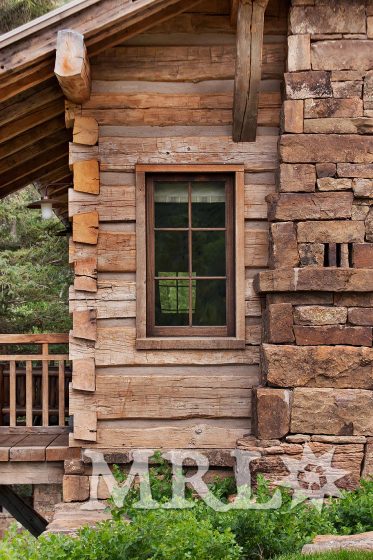 A photo of MRL’s reclaimed hand-hewn timbers and siding, oak wall paneling, trim, and flooring and rafter stock clad ceilings in the Charlie Mountain project.