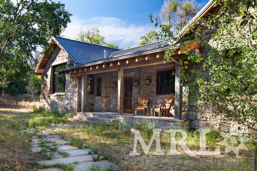 A photo of our reclaimed hand-hewn timbers and paneling along with rafter stock siding and paneling both inside and out of this Grazing Pastures project.