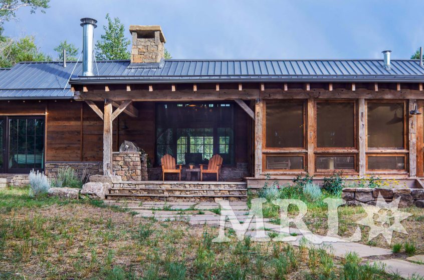 A photo of our reclaimed hand-hewn timbers and paneling along with rafter stock siding and paneling both inside and out of this Grazing Pastures project.