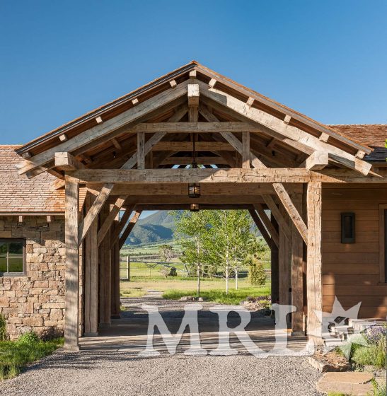 A photo of our oak ceiling paneling and hand-hewn timbers inside and out of the Legacy Ranch project.