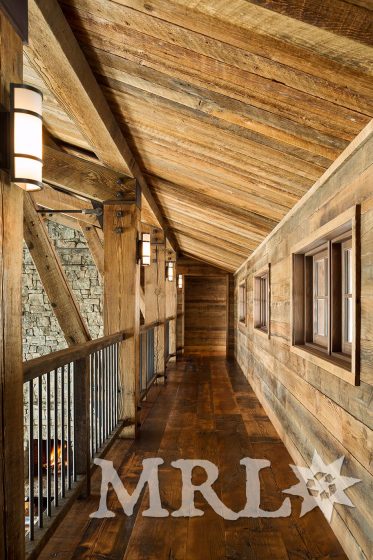 A photo of our reclaimed timbers, corral board and rafter stock siding and paneling throughout this Phillips Ridge project.