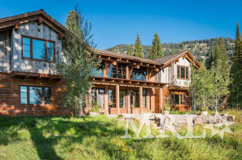 A photo of our reclaimed timbers, corral board and rafter stock siding and paneling throughout this Phillips Ridge project.